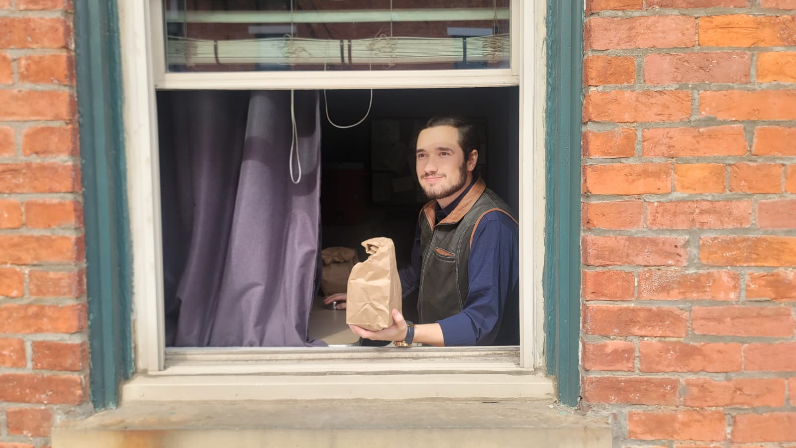 Handing out lunches at the sandwich window.
